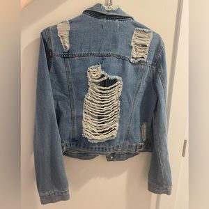 Cute jean jacket. Denim. With rips for style.